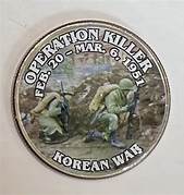 A round metal badge with a picture of soldiers

Description automatically generated