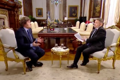 Javier Milei, ayer, en la conversación con Jonathan Viale, en la Casa Rosada; detrás de cámara, está Santiago Caputo, quien luego interrumpió la grabación