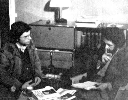 A couple of men sitting on a table
AI-generated content may be incorrect.