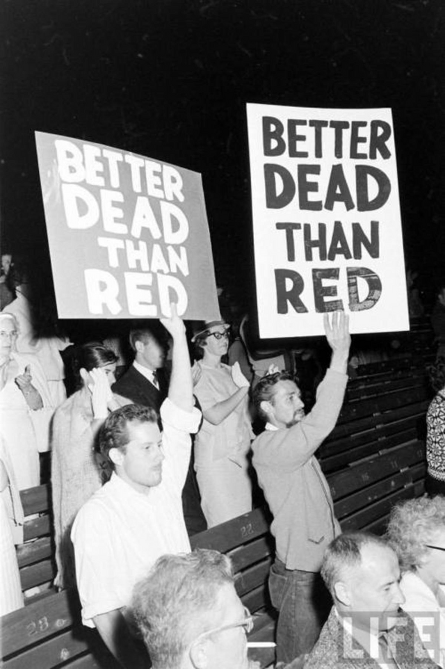 A group of people holding signs

Description automatically generated