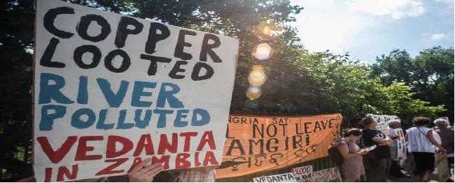 A group of people holding signs Description automatically generated