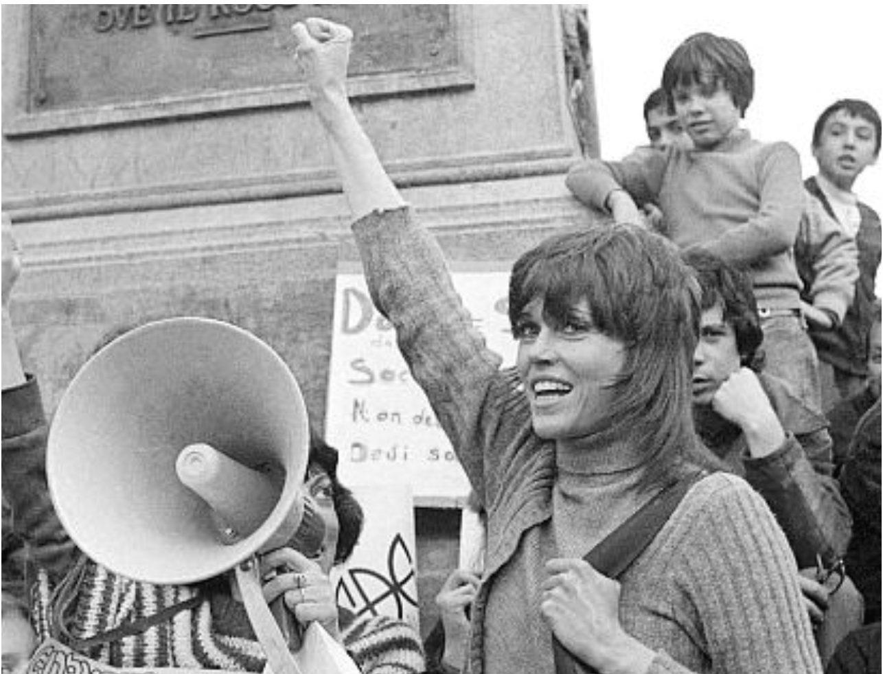 A person holding a megaphone

Description automatically generated