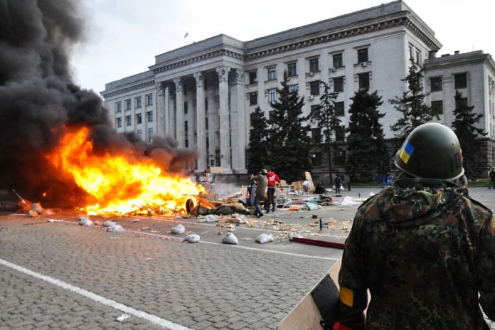 A person in a helmet with a fire on the street
AI-generated content may be incorrect.