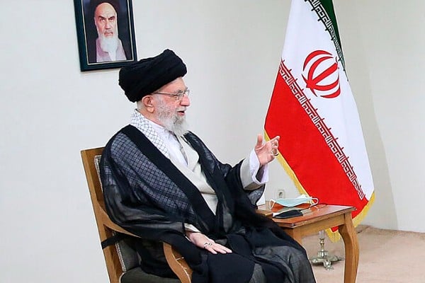 A person sitting in a chair with a flag
AI-generated content may be incorrect.