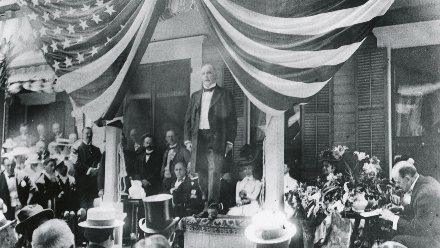 A person standing on a stage
AI-generated content may be incorrect.