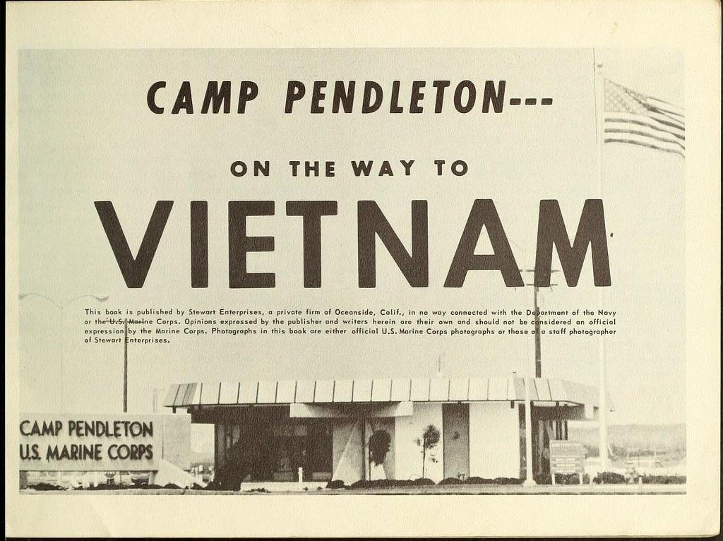 A sign with a flag and a building

Description automatically generated