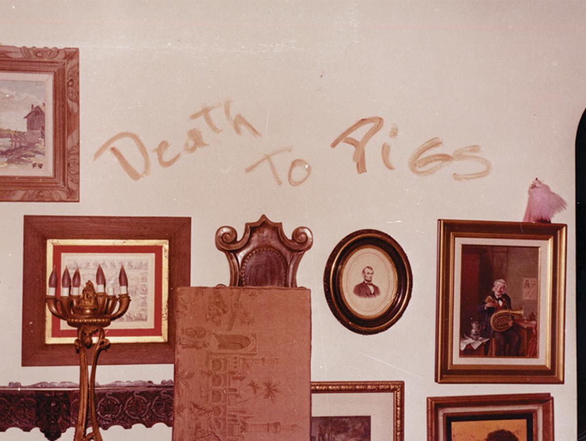 A wall with pictures and writing on it
AI-generated content may be incorrect.