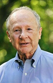 An old person in a blue shirt

Description automatically generated