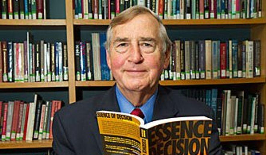 Graham T. Allison Jr., Douglas Dillon Professor of Government in the John F. Kennedy School of Government and Director of Belfer Center for Science and International Affairs at the JFK School of Government, poses with his book about the Cuban missile crisis of 1962. Jon Chase/Harvard Staff Photographer