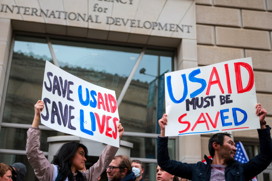 A group of people holding signs

AI-generated content may be incorrect.