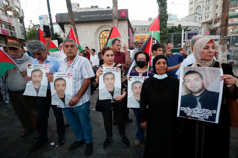 A group of people holding signs

Description automatically generated