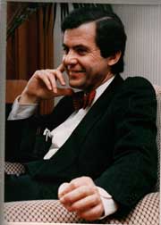 A person in a suit and bow tie AI-generated content may be incorrect.