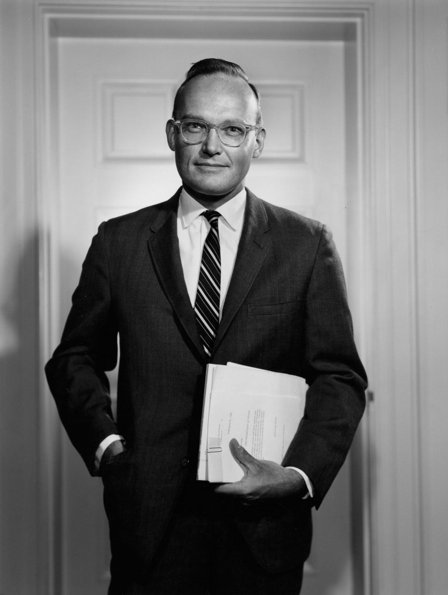 A person in a suit holding a paper

AI-generated content may be incorrect.