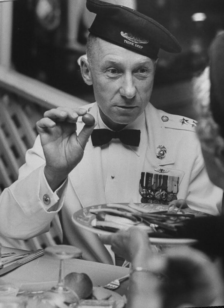 A person in a uniform holding a plate of food

Description automatically generated