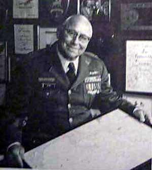 A person in military uniform holding a piece of paper

Description automatically generated