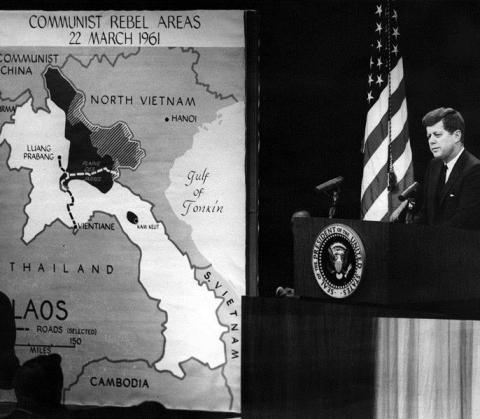 A person standing at a podium with microphones

Description automatically generated