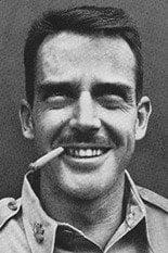 A person with a cigar in his mouth

Description automatically generated