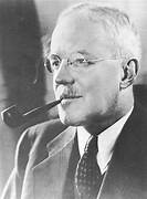 A person with a pipe in his mouth
Description automatically generated