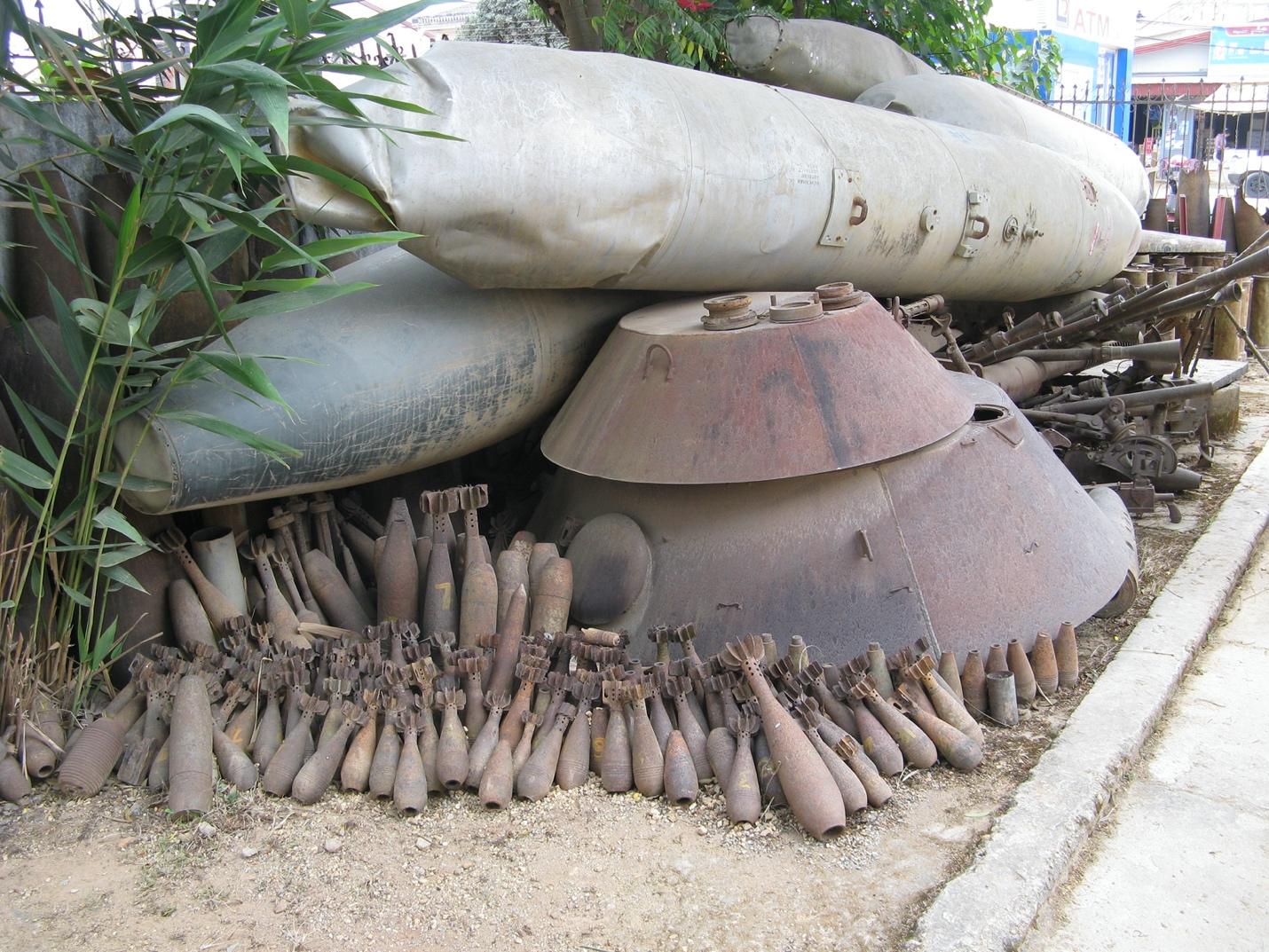 A pile of rusty objects on the ground
Description automatically generated