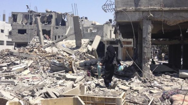 Nissana Sukar in the rubble outside her home in Shujaiyah.