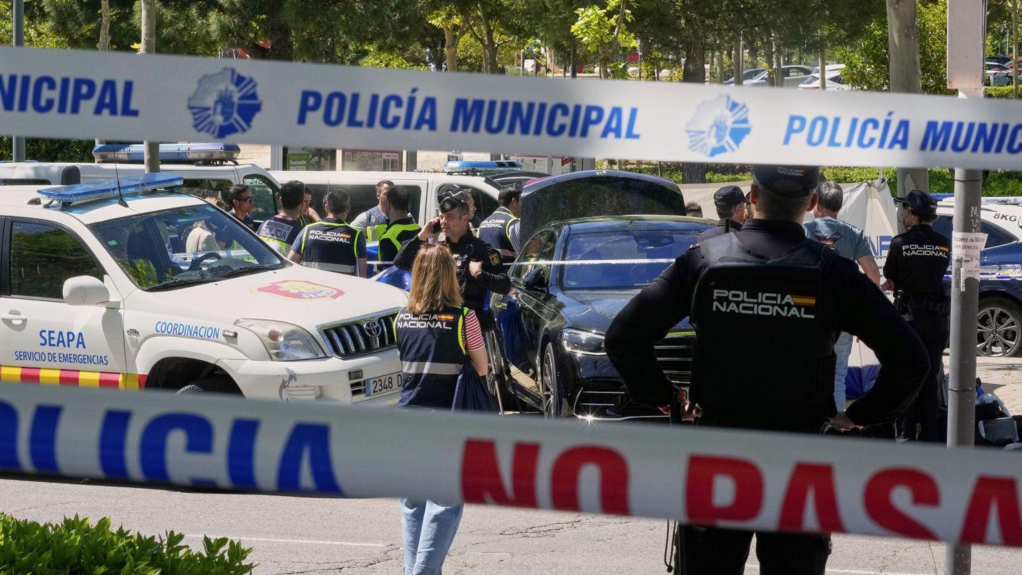 Police officers cordon off the area outside The American School of Madrid shortly after the former senior aide to ex-Ukrainian president Viktor Yanukovych was shot.