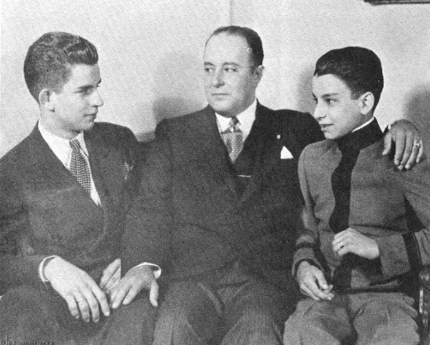 A group of men sitting on a couch

AI-generated content may be incorrect.