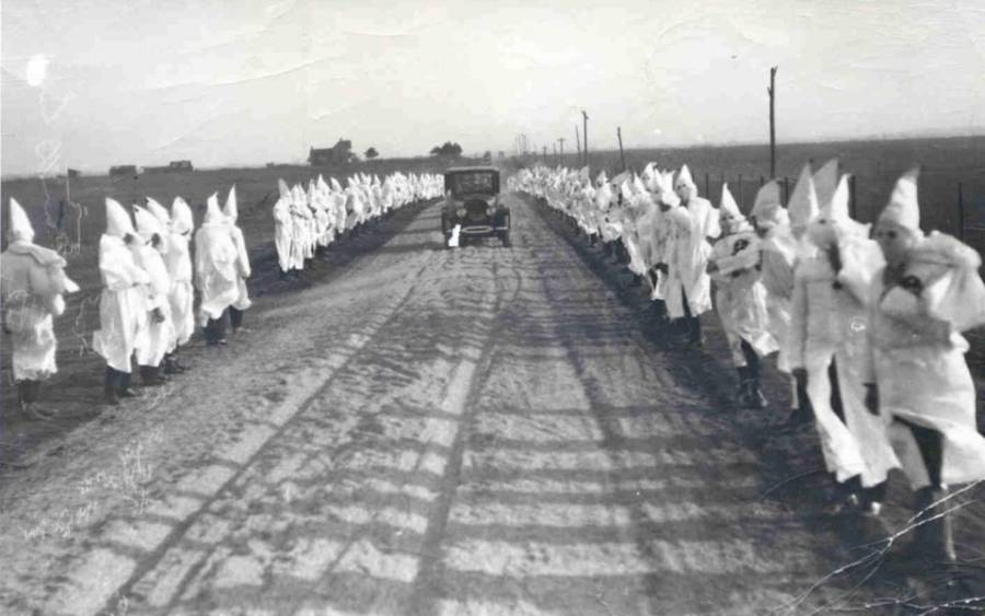 A group of people in white coats Description automatically generated