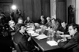 A group of people sitting around a table

AI-generated content may be incorrect.