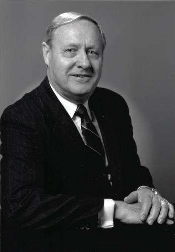 A person in a suit and tie
Description automatically generated