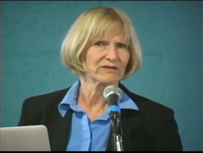 A person in a suit speaking into a microphone

AI-generated content may be incorrect.