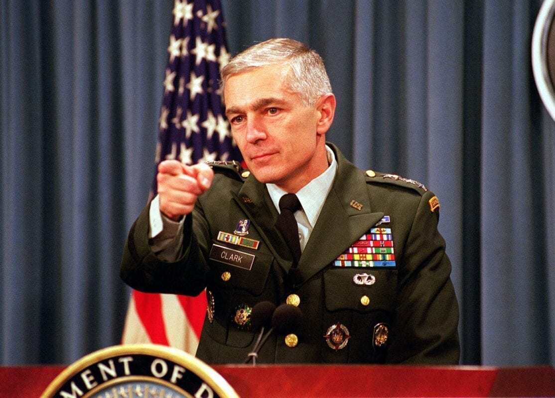A person in military uniform pointing at camera

AI-generated content may be incorrect.