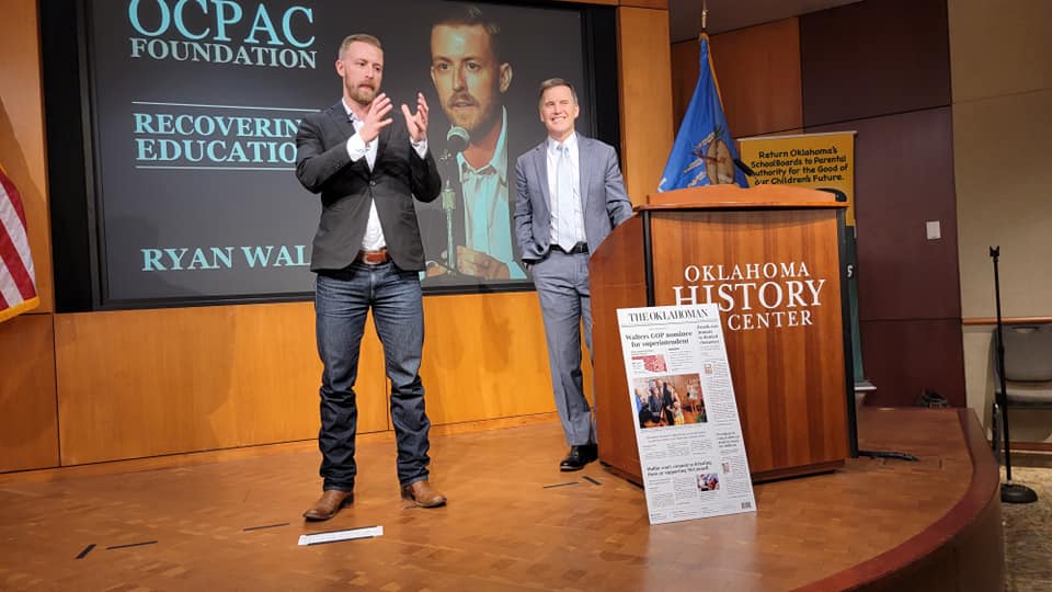 A person standing on a podium with a person standing on a podium Description automatically generated