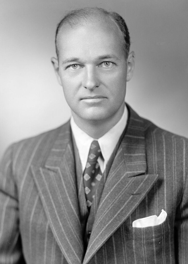 Head and shoulders portrait of a dignified man in his forties, wearing a suit and tie.