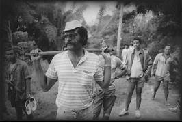 A group of men walking with a baseball bat
AI-generated content may be incorrect.