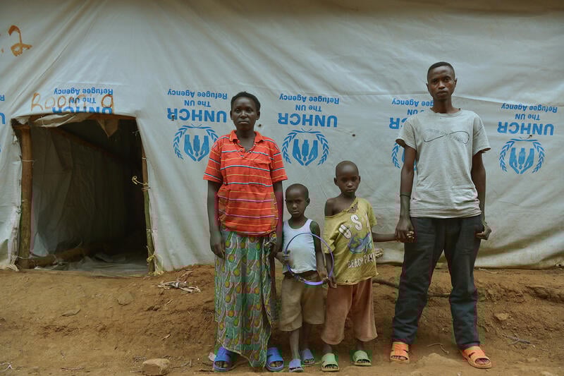 A group of people standing in front of a tent

AI-generated content may be incorrect.