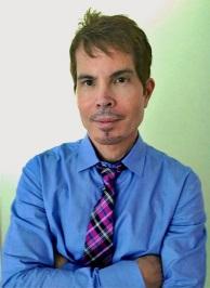 A person in a blue shirt and tie
Description automatically generated