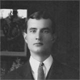 A person in a suit and tie
Description automatically generated