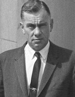 A person in a suit and tie
Description automatically generated