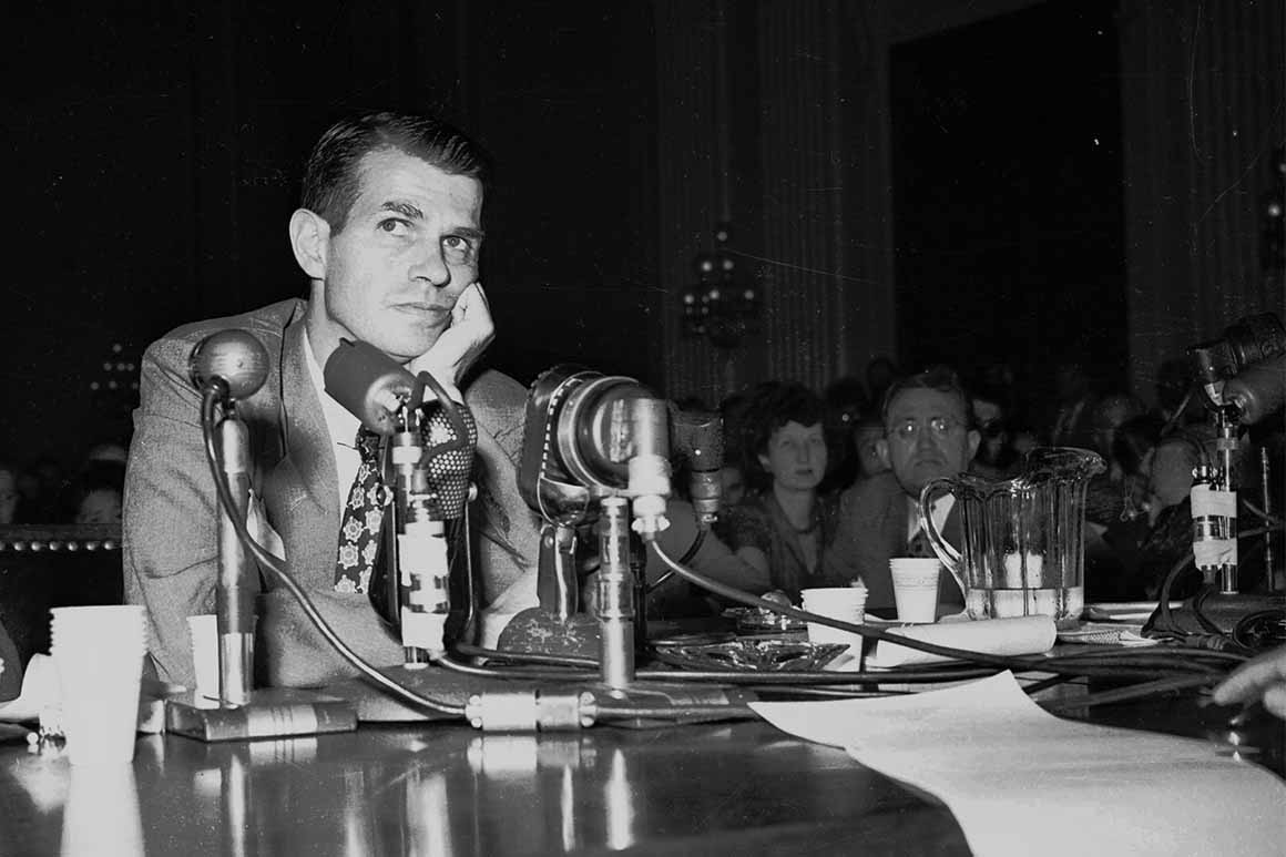 A person sitting at a table with microphones
AI-generated content may be incorrect.