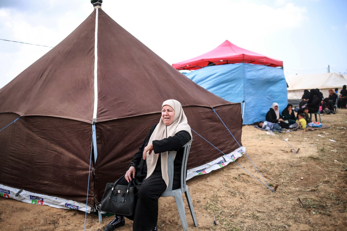 A person sitting in a chair next to a tent

AI-generated content may be incorrect.