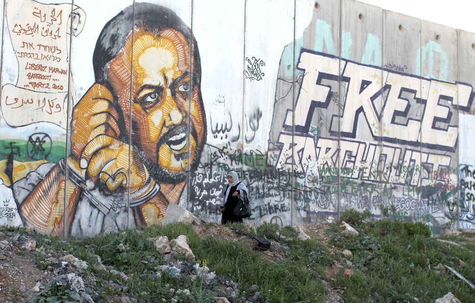 A person standing in front of a wall with graffiti

AI-generated content may be incorrect.