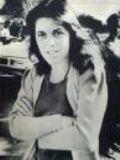 A person with her arms crossed
Description automatically generated