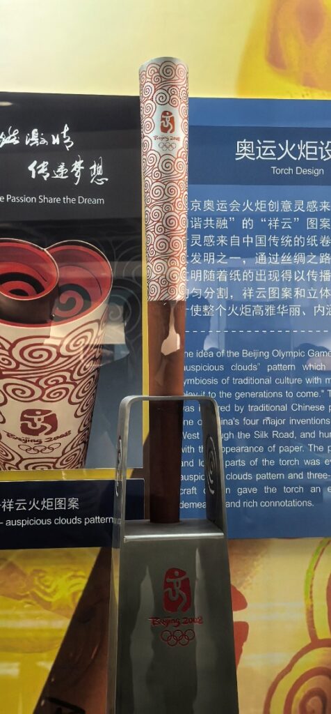 A glass display case with a tall brown object

AI-generated content may be incorrect.