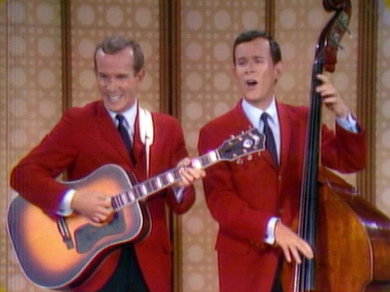 A group of men in red suits playing instruments

AI-generated content may be incorrect.