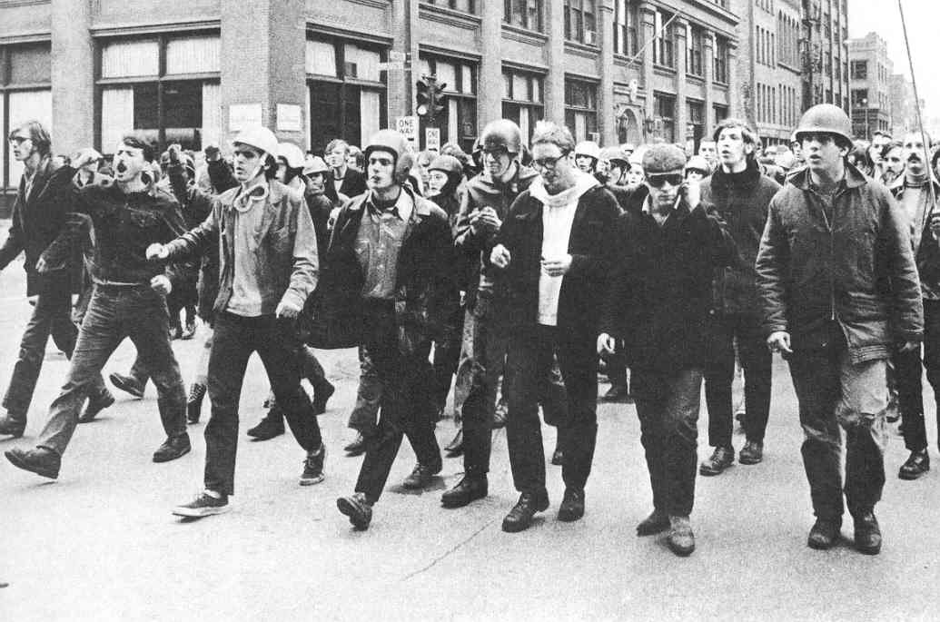A group of people marching in a street
AI-generated content may be incorrect.