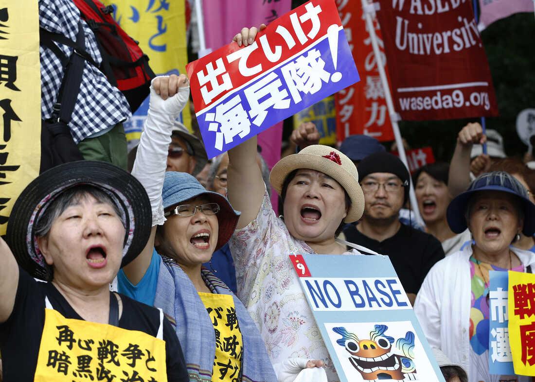 A group of people protesting
Description automatically generated
