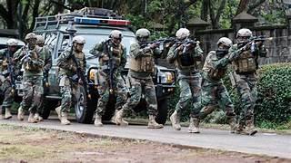 A group of soldiers in uniform holding guns

AI-generated content may be incorrect.
