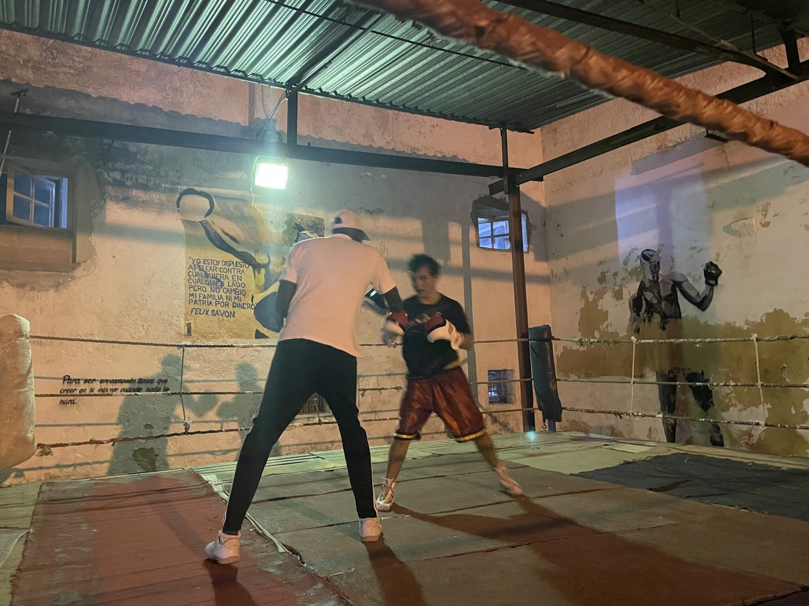 A person and person boxing in a boxing ring
AI-generated content may be incorrect.