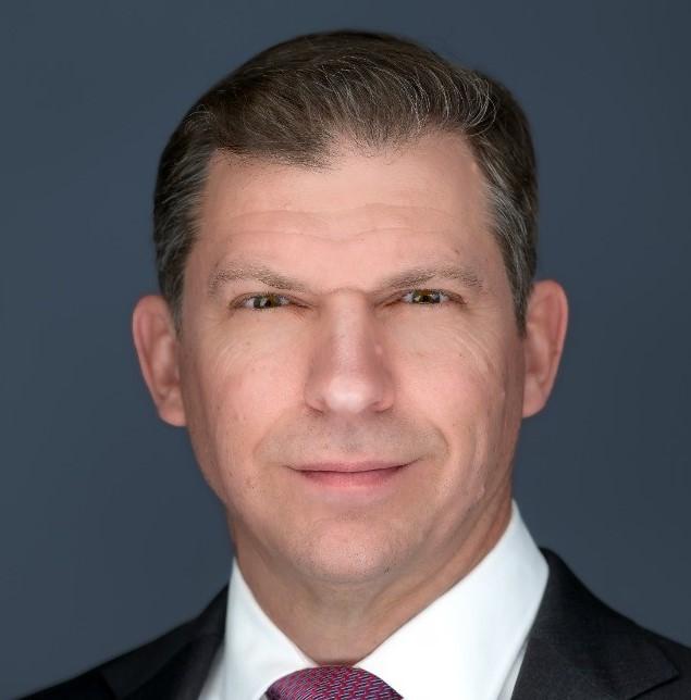 A person in a suit and tie

AI-generated content may be incorrect.
