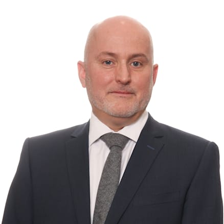 A person in a suit
Description automatically generated